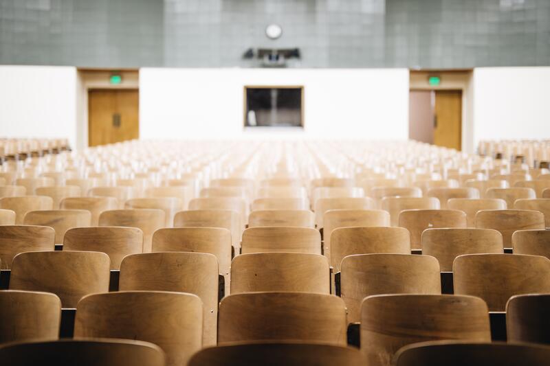 Empty chairs arranged in an auditorium