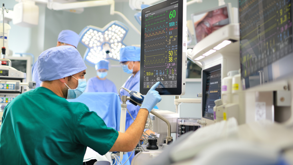 A photo showing an hospital environment with man wearing scrubs and touchscreens