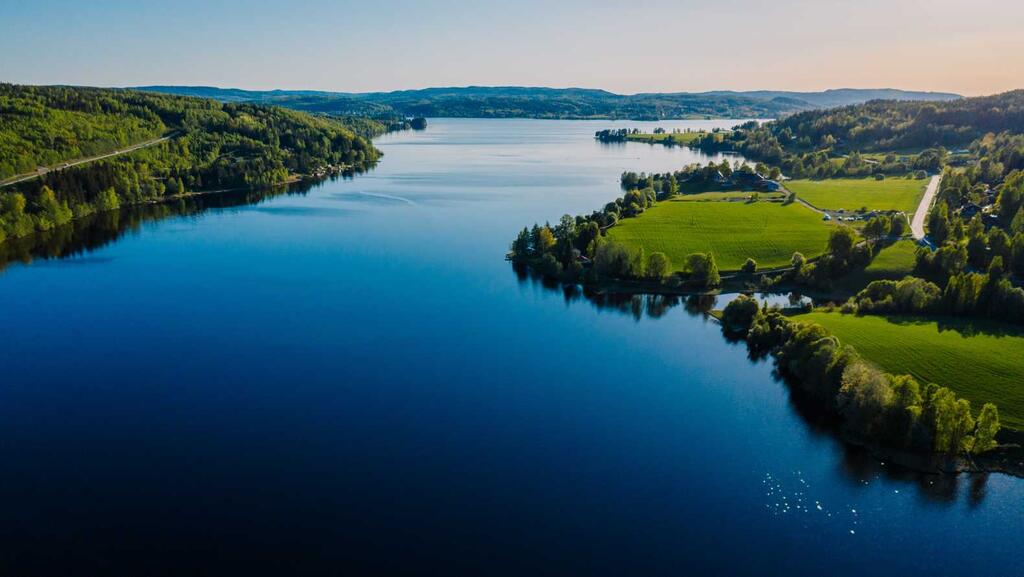 Landscape image from bird-eye-view of a big lake and green grass