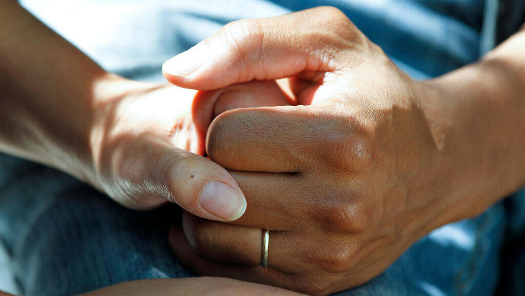Close-up of holding hands, hospital setting